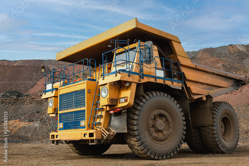 Large dump truck for removal of rock mass from the quarry for open-pit mining of minerals. Initial stage of melalurgy, machinery for the extraction of raw ore.