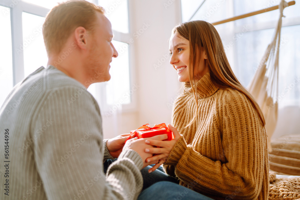 Young couple at home celebrating Valentine's Day. Romantic day together. Young couple at home celebrating Valentine's Day. Romantic day together.