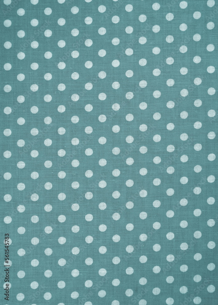 Green with white polka dots classic pattern fabric background texture.