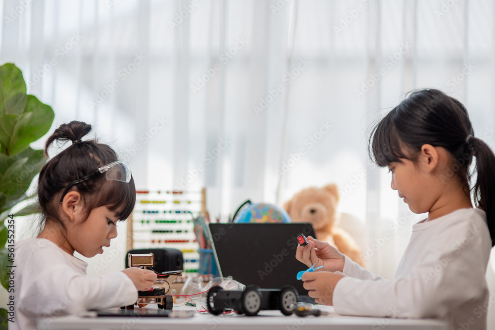 Asia students learn at home in coding robot cars and electronic board cables in STEM, STEAM, mathematics engineering science technology computer code in robotics for kids concept. Asia students learn at home in coding robot cars and electronic board cables in STEM, STEAM, mathematics engineering science technology computer code in robotics for kids concept.
