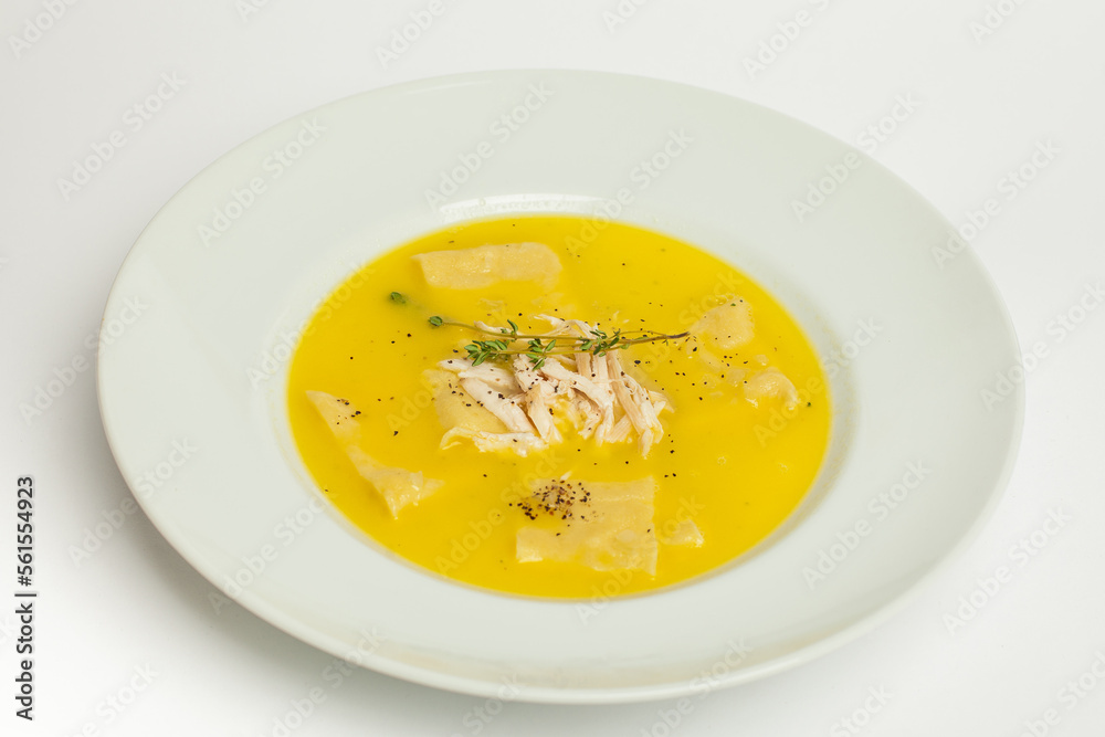 Chicken soup on white. Homemade fresh creamy soup with chicken, vegetables in white bowl close up Chicken soup on white. Homemade fresh creamy soup with chicken, vegetables in white bowl close up