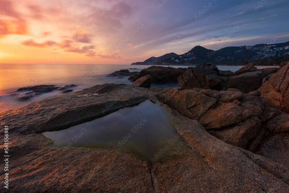 Artistic seascape with granite rocks on sea coast in front of colorful sunrise sky Samui Thailand