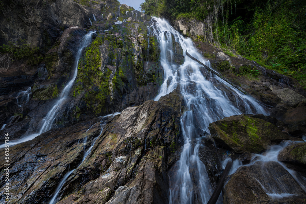 Naklejka premium Picturesque waterfall cascade on granite rocks in dense tropical forest, Namuang 2, Samui, Thailand