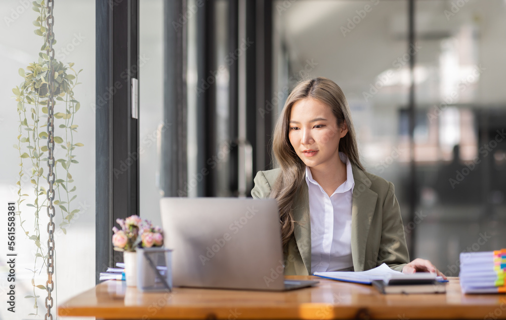 portrait of business Asian woman Accounting using calculating income-expenditure and analyzing real estate investment data report Financial and tax systems concept. portrait of business Asian woman Accounting using calculating income-expenditure and analyzing real estate investment data report Financial and tax systems concept.
