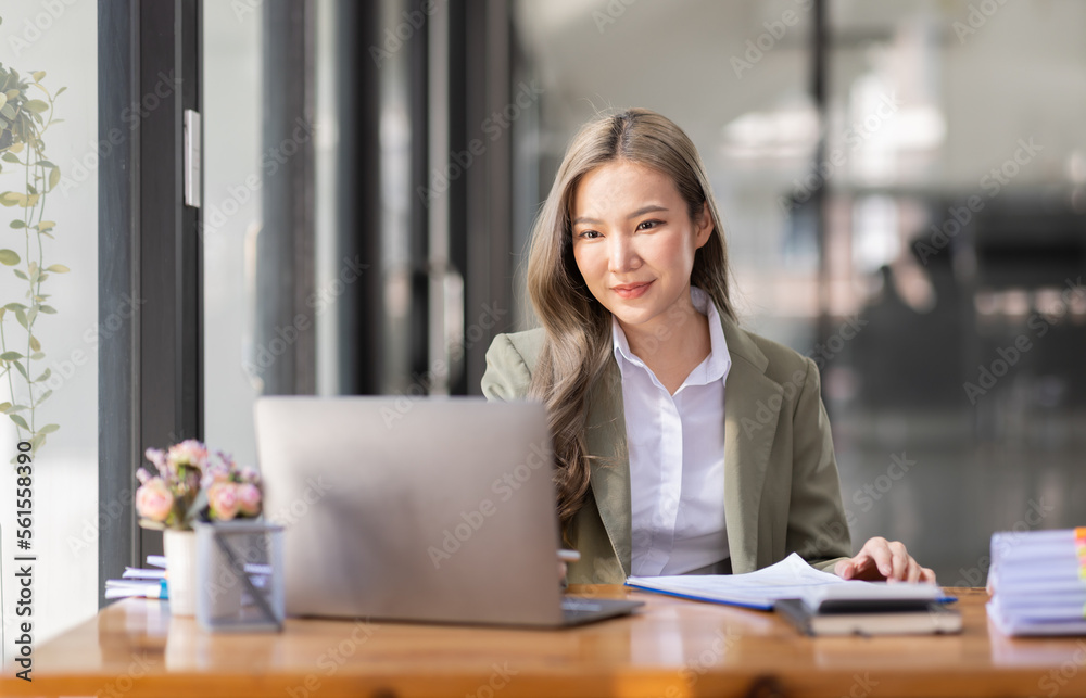 portrait of business Asian woman Accounting using calculating income-expenditure and analyzing real estate investment data report Financial and tax systems concept. portrait of business Asian woman Accounting using calculating income-expenditure and analyzing real estate investment data report Financial and tax systems concept.