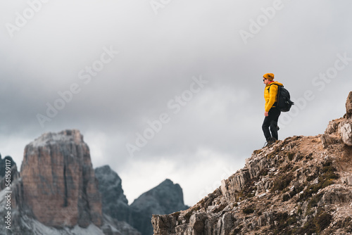 Active climber on top of mountain. enjoying the view. Hiker winning reaching life goal, succes, freedom and happiness, achievement in mountain, Dolomites, Italy
