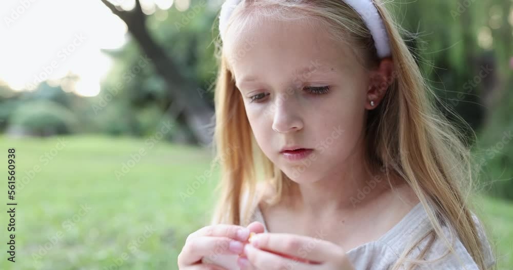 Close up emotional portrait of caucasian smiling teen girl with blonde hair seven years old. Funny cute child in summer park on sunset. Happy kid having fun Close up emotional portrait of caucasian smiling teen girl with blonde hair seven years old. Funny cute child in summer park on sunset. Happy kid having fun