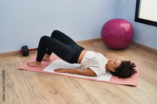 Young african american woman smiling confident training abs exercise at sport center