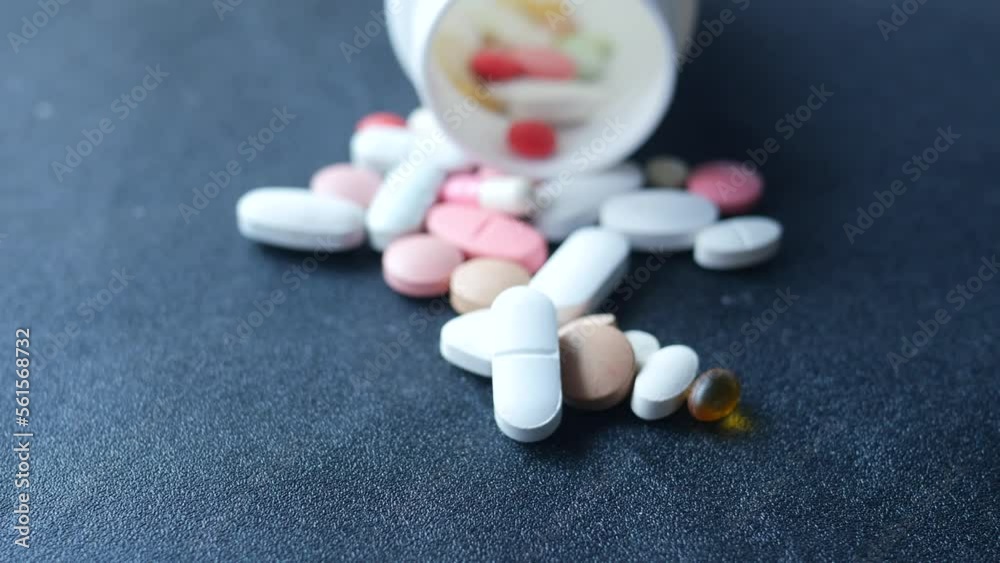 Close up of many colorful pills and capsules on black background Close up of many colorful pills and capsules on black background