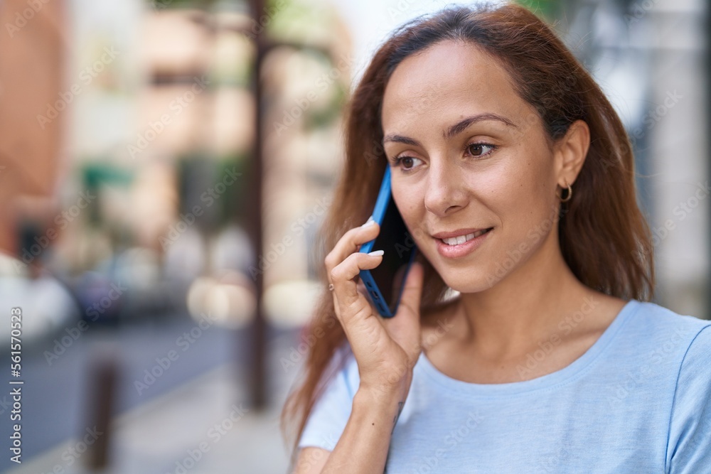 Young woman smiling confident talking on the smartphone at street Young woman smiling confident talking on the smartphone at street