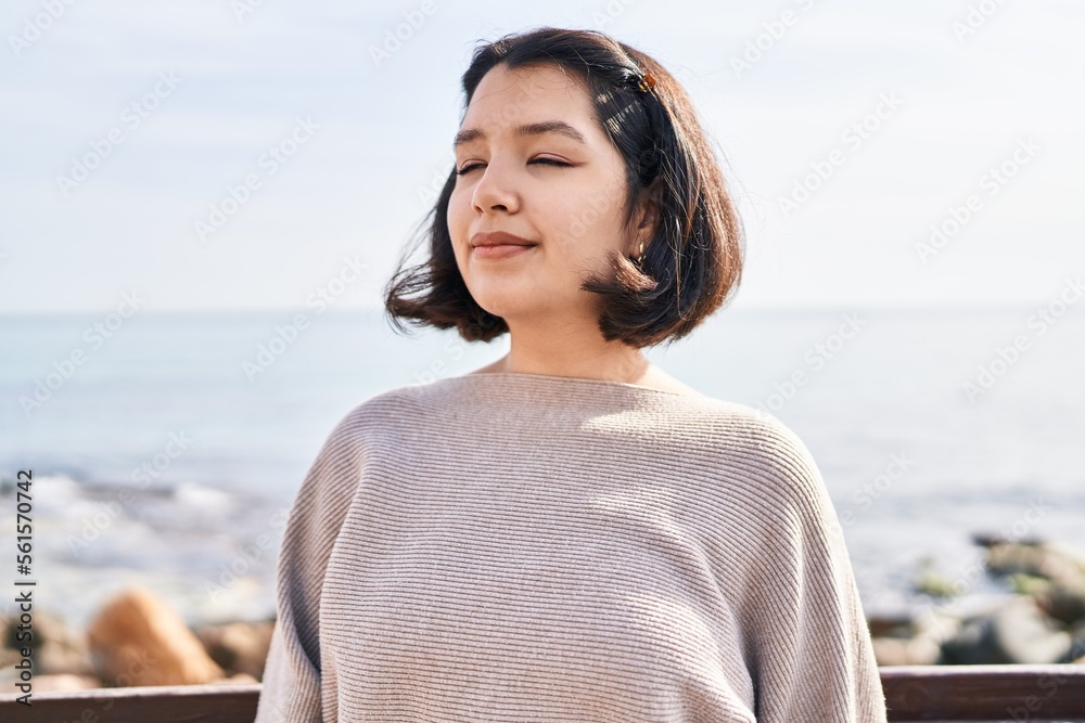 Young woman smiling confident breathing at seaside Young woman smiling confident breathing at seaside