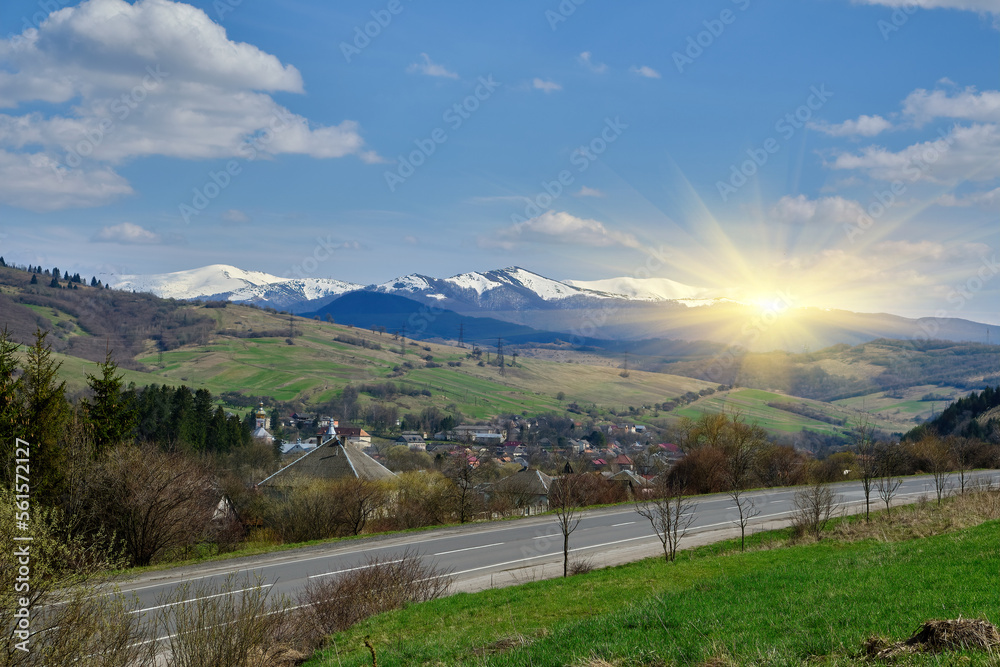 foggy weather in spring. carpathian countryside landscape in mountains. asphalt road winding through forest