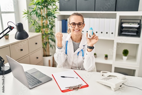 Wallpaper Mural Young doctor woman wearing uniform and stethoscope screaming proud, celebrating victory and success very excited with raised arms Torontodigital.ca
