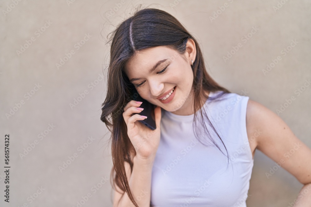 Young caucasian woman smiling confident talking on the smartphone over isolated white background Young caucasian woman smiling confident talking on the smartphone over isolated white background
