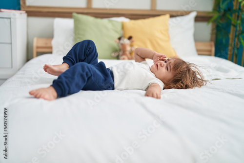 Adorable hispanic toddler lying on bed crying at bedroom © Krakenimages.com