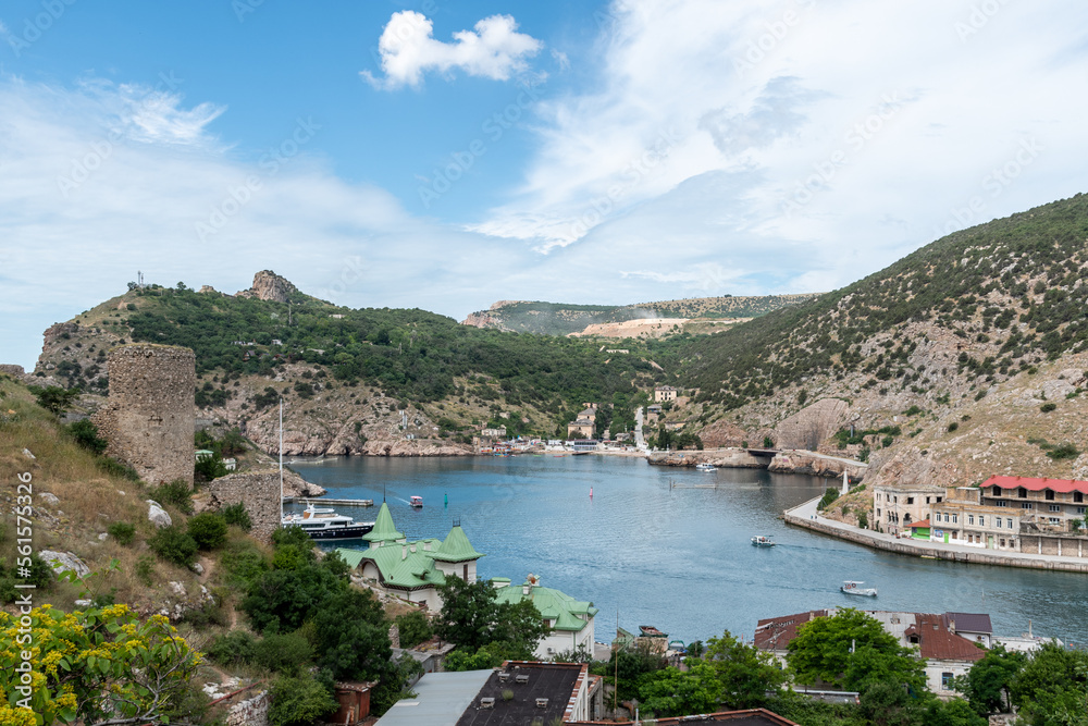 Aerial panoramic view of Balaklava bay in Crimea, mountain cliffs and sea with ships. Beautiful nature panorama landscape
