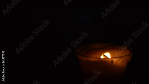 close-up red flame of a candle. candle burning in the dark background