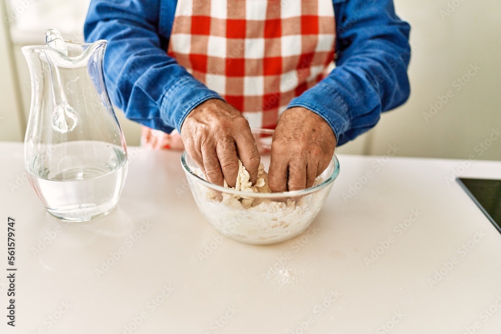 Senior man cooking dough at kitchen Senior man cooking dough at kitchen