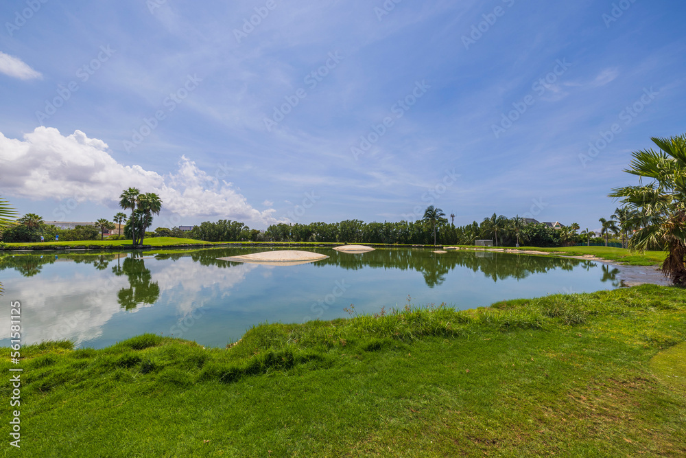 Beautiful view of blue pond water surface on blue sky with rear white clouds background. Aruba. Beautiful view of blue pond water surface on blue sky with rear white clouds background. Aruba.