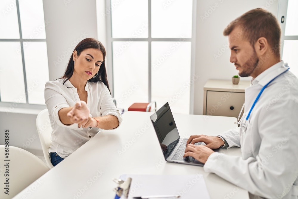 Man and woman doctor and patient having medical consultation at clinic Man and woman doctor and patient having medical consultation at clinic