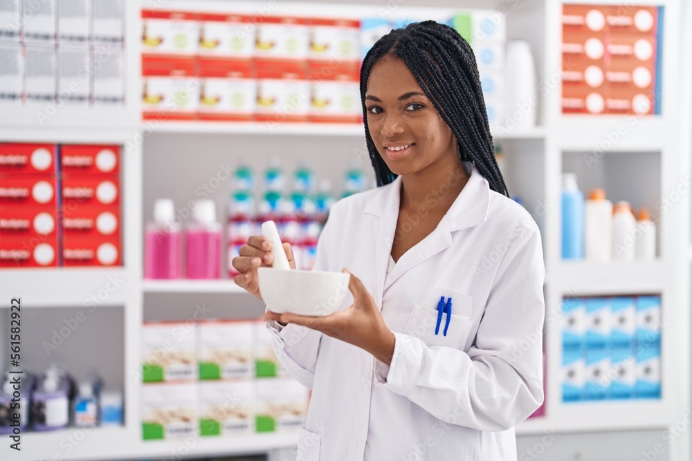 African american woman pharmacist smiling confident working at pharmacy