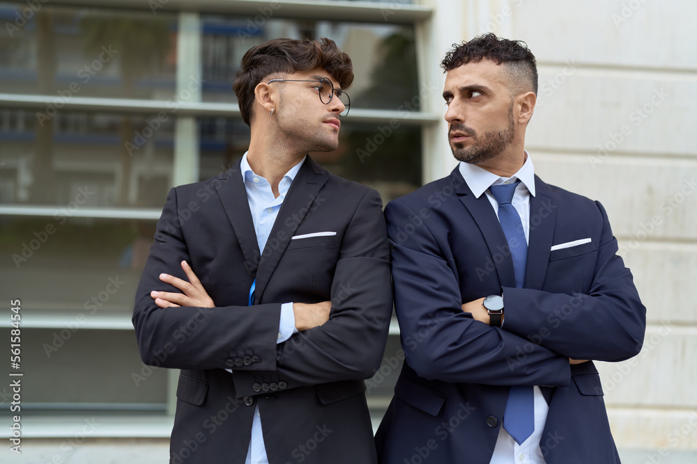 Two hispanic men business workers standing with arms crossed gesture at street Two hispanic men business workers standing with arms crossed gesture at street