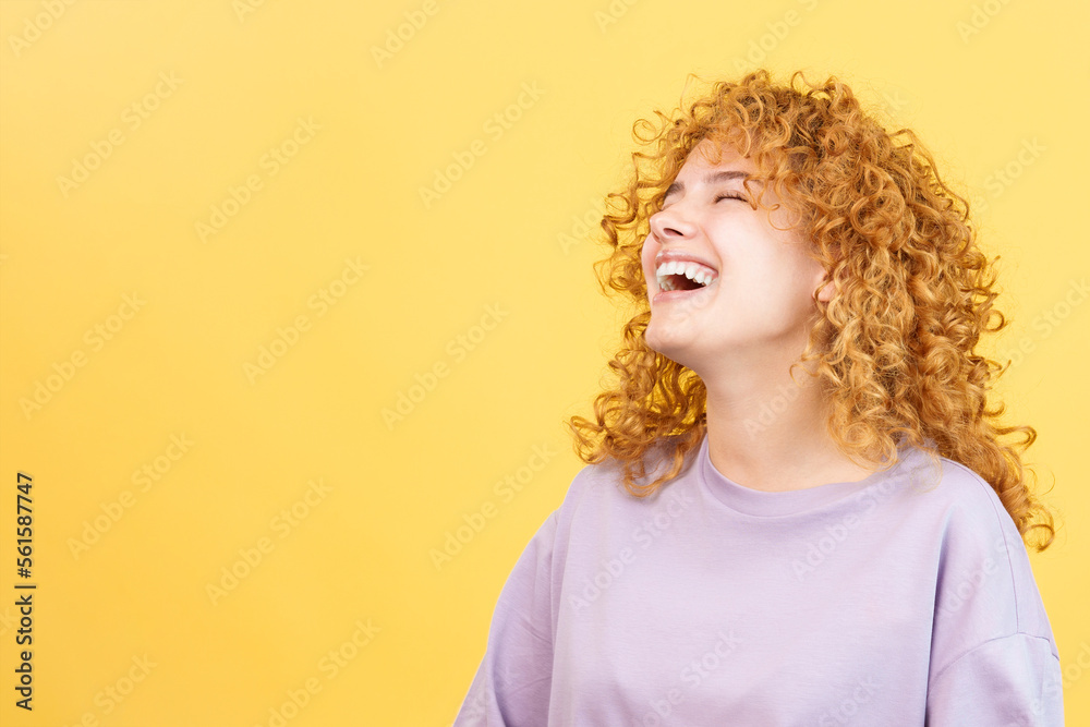 Woman with curly hair and casual clothes laughing Woman with curly hair and casual clothes laughing