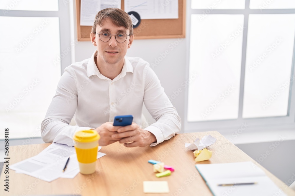 Young caucasian man business worker using smartphone working at office Young caucasian man business worker using smartphone working at office