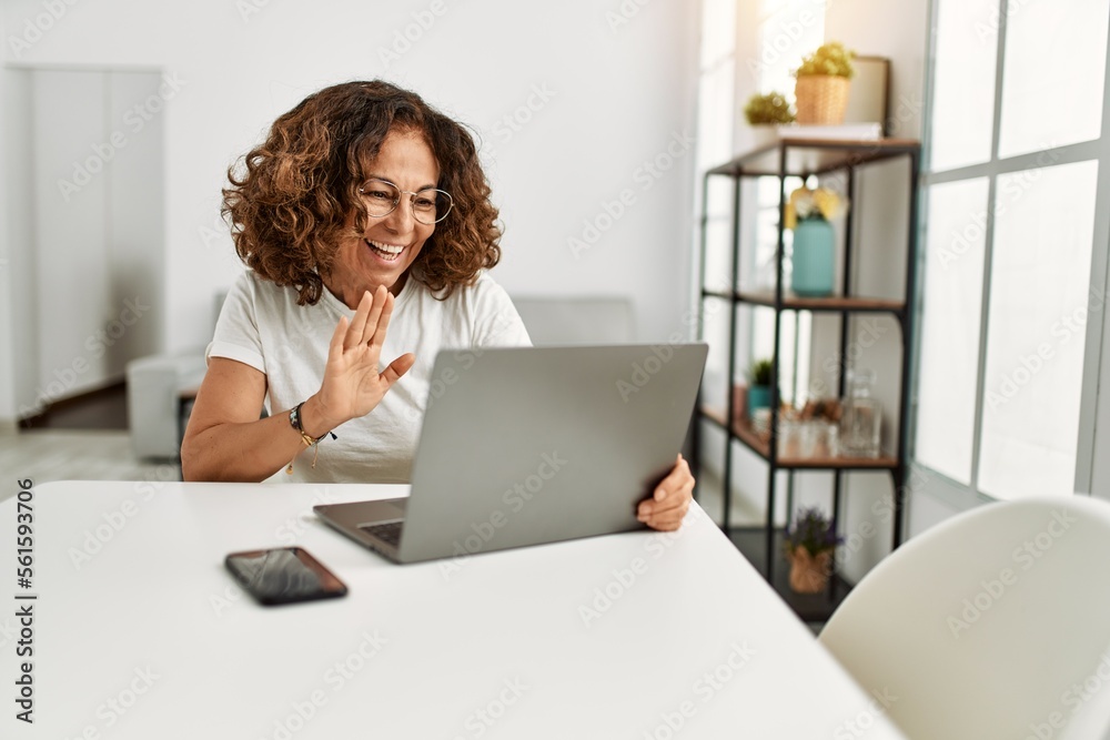 Middle age hispanic woman smiling confident having video call at home Middle age hispanic woman smiling confident having video call at home