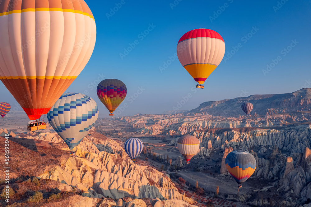 Amazing landscape view sunrise in Cappadocia with colorful hot air balloon deep canyons, valleys. Concept banner travel Turkey aerial top view