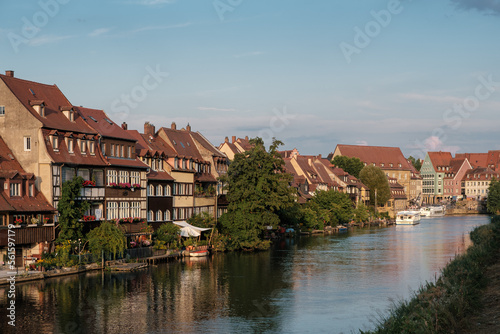 view to the historical quarter on the bank of the Regnitz river Bamberg with ship.