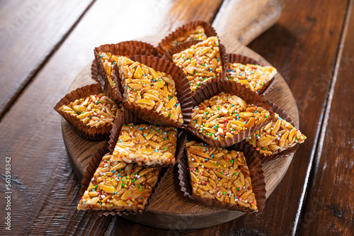Desserts with almonds, peanuts and seeds in caramel. Traditional Sardinian sweet. Sweet squares. Almond Gateau, sarda Food, for smartphones and social networks. Copy space