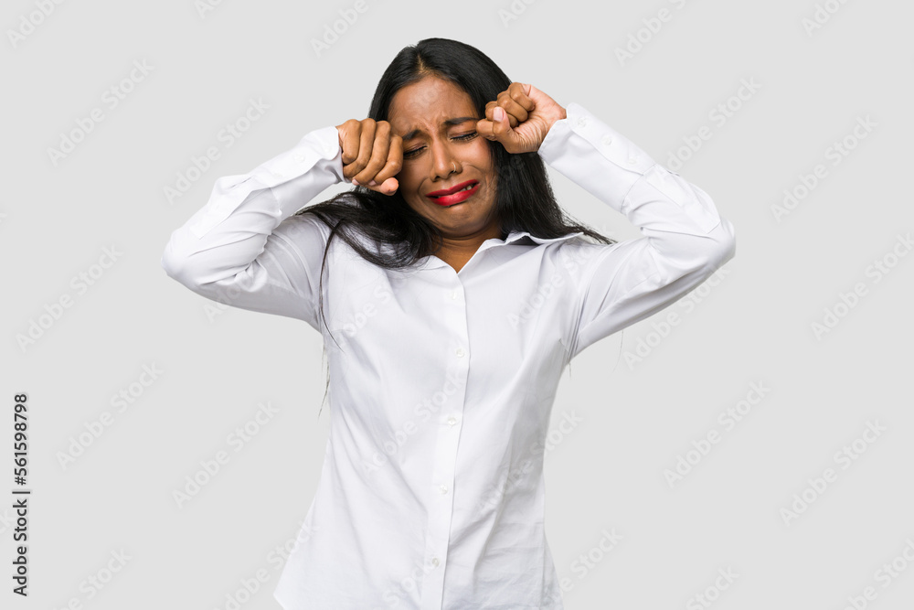 Young Indian woman cut out isolated on white background whining and crying disconsolately. Young Indian woman cut out isolated on white background whining and crying disconsolately.