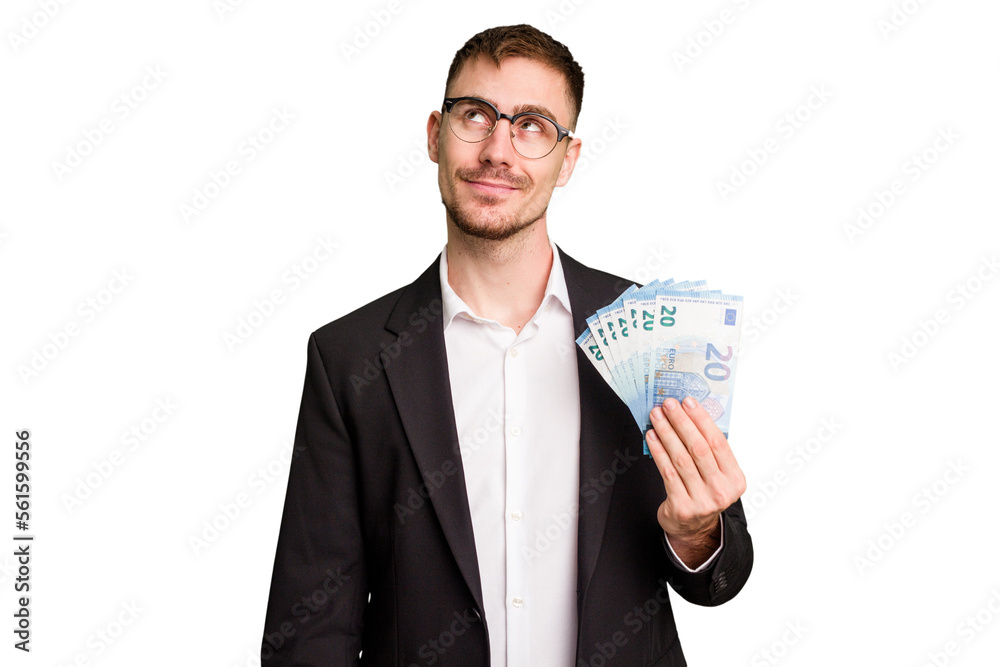 Young business caucasian man holding euro banknotes isolated cut out dreaming of achieving goals and purposes Young business caucasian man holding euro banknotes isolated cut out dreaming of achieving goals and purposes
