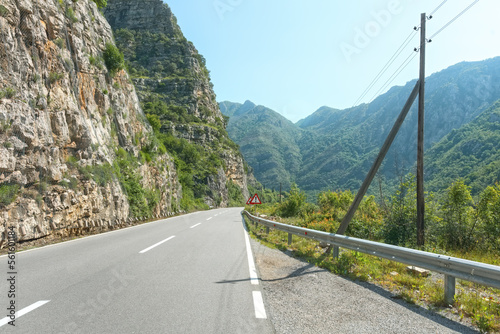 A beautiful view of the mountain asphalt road, near the steep cliffs. Traveling by car in Montenegro. photo