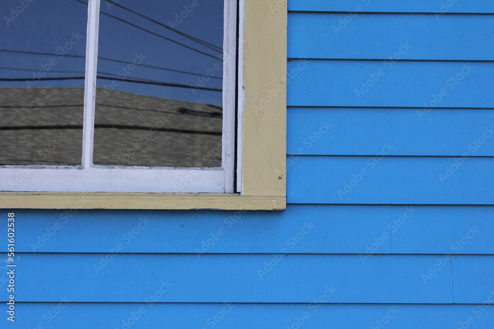 Window on blue-painted home Window on blue-painted home