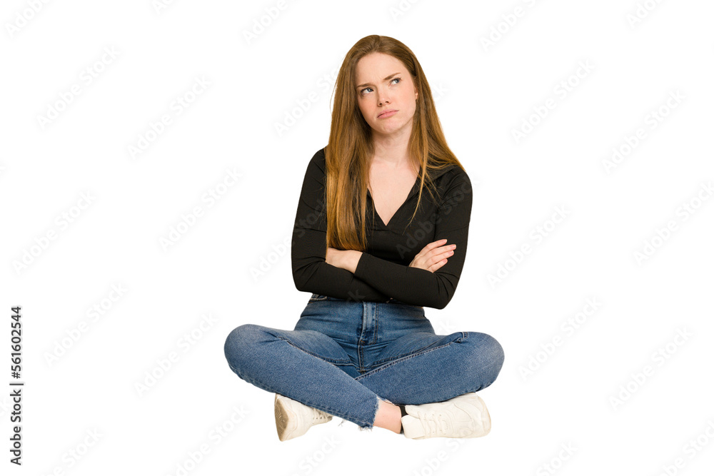 Young redhead woman sitting on the floor cut out isolated showing number two with fingers. Young redhead woman sitting on the floor cut out isolated showing number two with fingers.