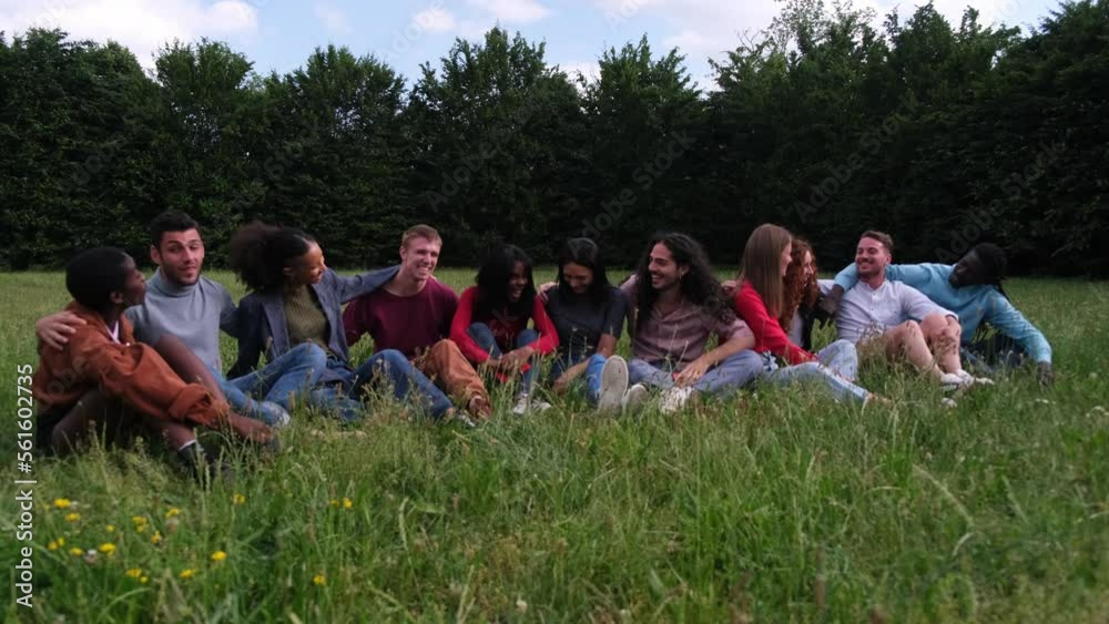 Diverse group of friends gathering in the park and enjoying an afternoon outdoors. concept freedom, multiculturalism, lifestyle Diverse group of friends gathering in the park and enjoying an afternoon outdoors. concept freedom, multiculturalism, lifestyle