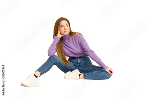 Young redhead woman sitting isolated cut out