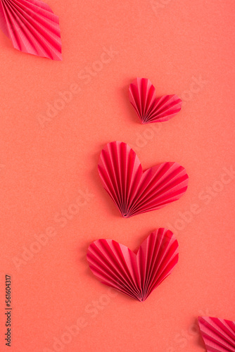 Monochrome red background with origami hearts. Family concept. Vertical view