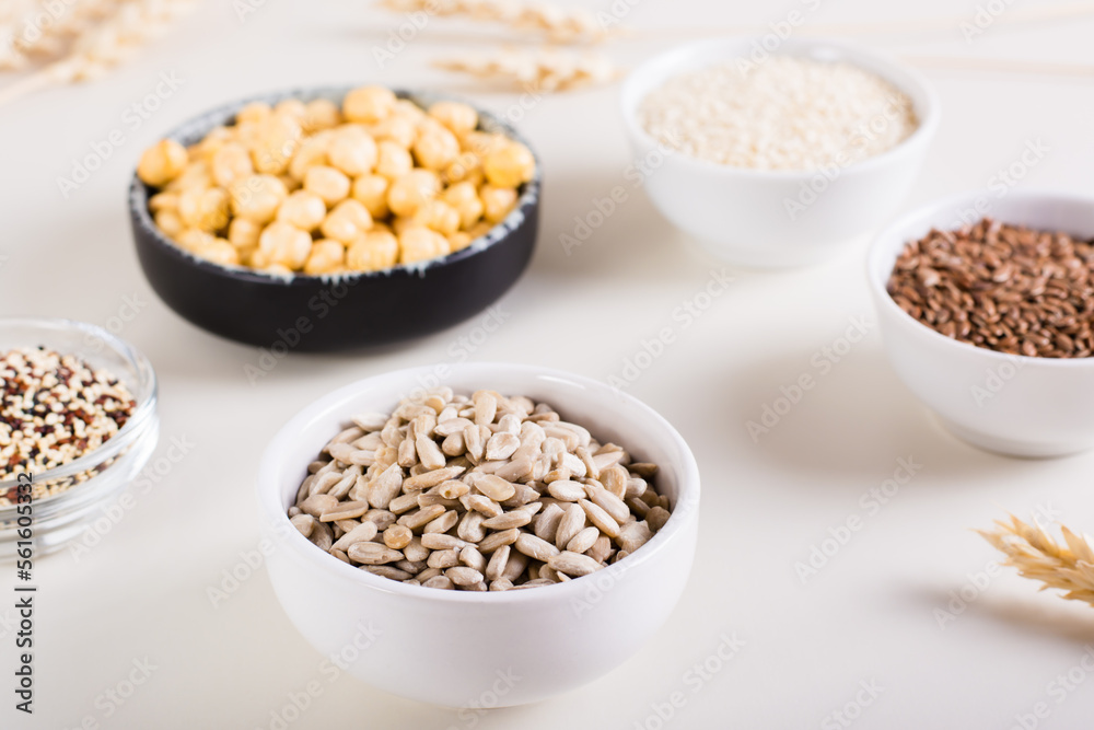 Sunflower seeds in a bowl and other seeds in bowls on the table. Healthy food. Sunflower seeds in a bowl and other seeds in bowls on the table. Healthy food.