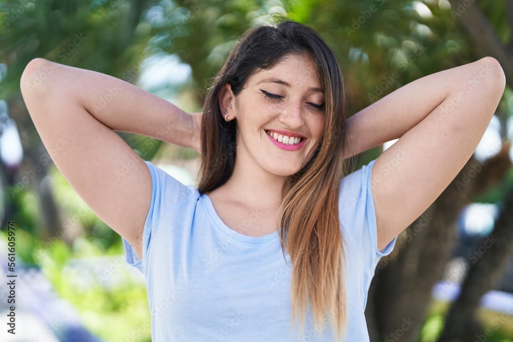 Young hispanic woman smiling confident standing at park