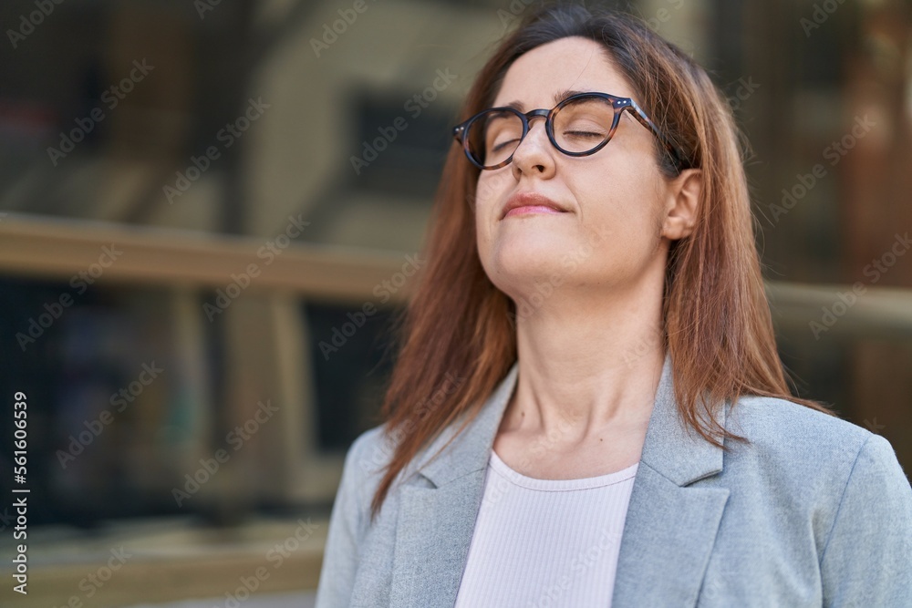 Young woman business worker breathing at street Young woman business worker breathing at street
