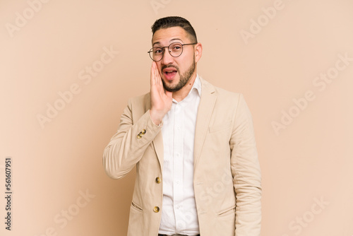 Adult latin business man cut out isolated shouts loud, keeps eyes opened and hands tense.