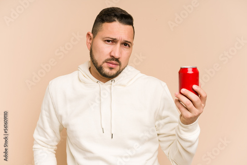 Adult latin man drinking cola refreshment isolated © Asier