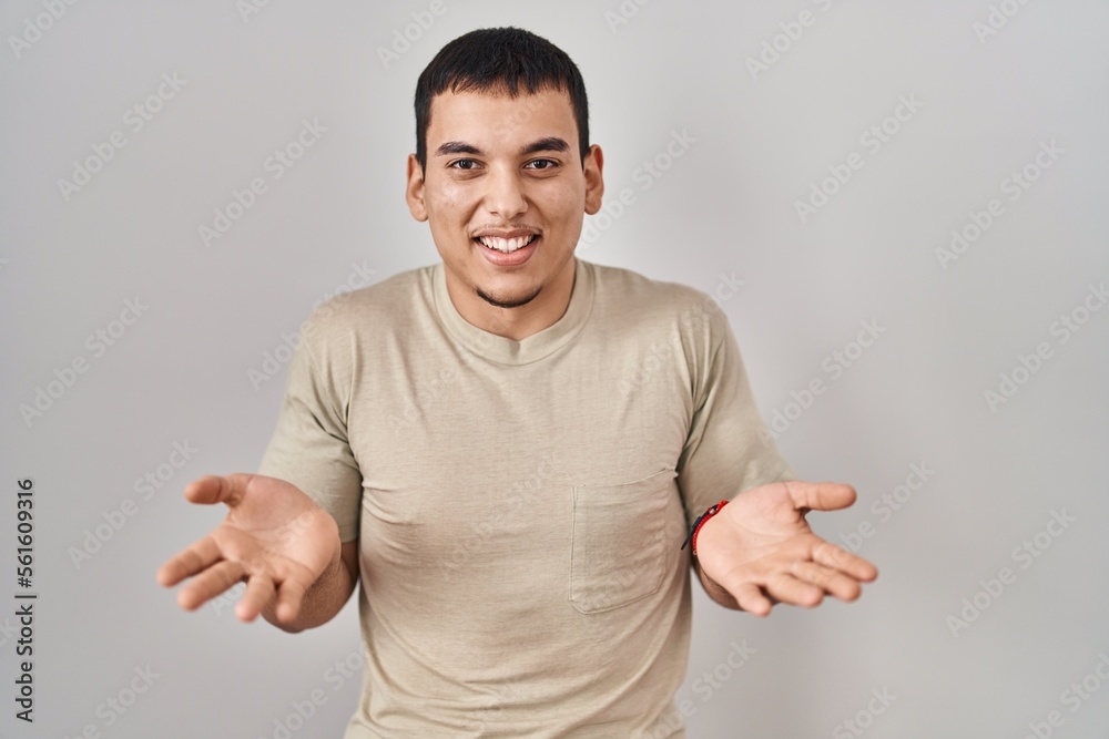 Young arab man wearing casual t shirt smiling cheerful with open arms as friendly welcome, positive and confident greetings Young arab man wearing casual t shirt smiling cheerful with open arms as friendly welcome, positive and confident greetings