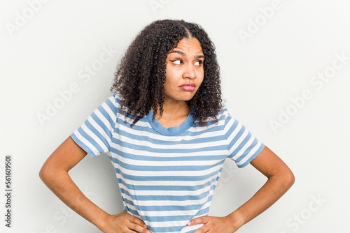 Young african american woman isolated on white background confused, feels doubtful and unsure.