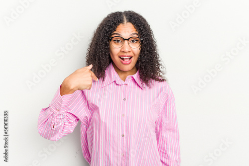 Young african american woman isolated on white background person pointing by hand to a shirt copy space  proud and confident