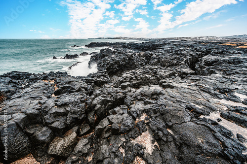 Brimketill lava rock pool - natural pool at the bottom of the cliffs, located on the Reykjanes Peninsula, west of the Grindavik, Iceland. photo