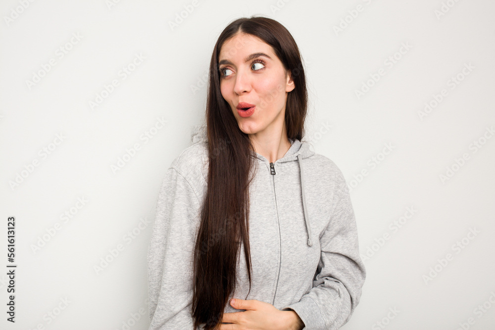 Young caucasian woman isolated on white background looks aside smiling, cheerful and pleasant. Young caucasian woman isolated on white background looks aside smiling, cheerful and pleasant.